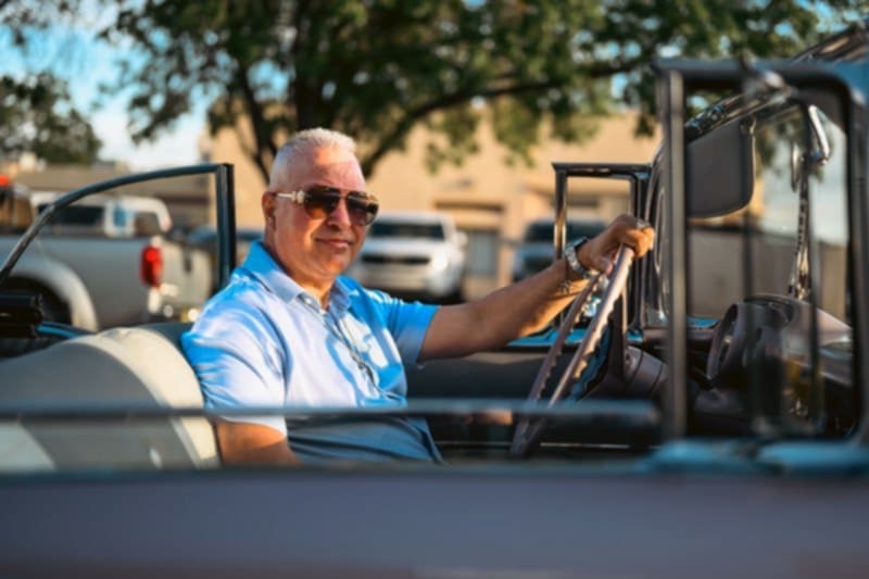 Foundation member in a classic convertible at an outdoor event