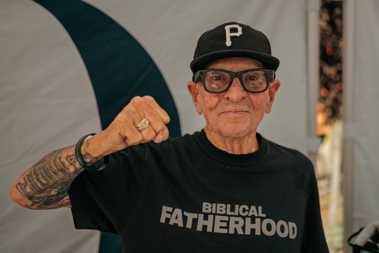 Volunteer raising his fist in a Biblical Fatherhood t-shirt at Duke Day